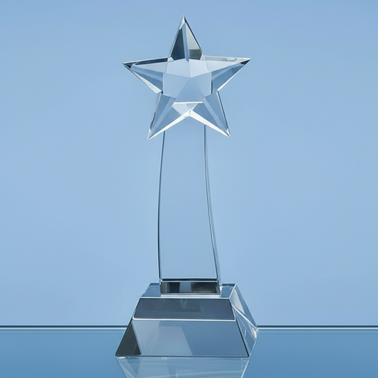 Clear glass star-shaped trophy on a blue background