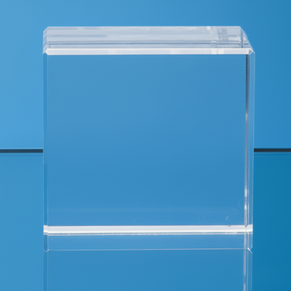 Clear GLASS block on a reflective surface with a blue background